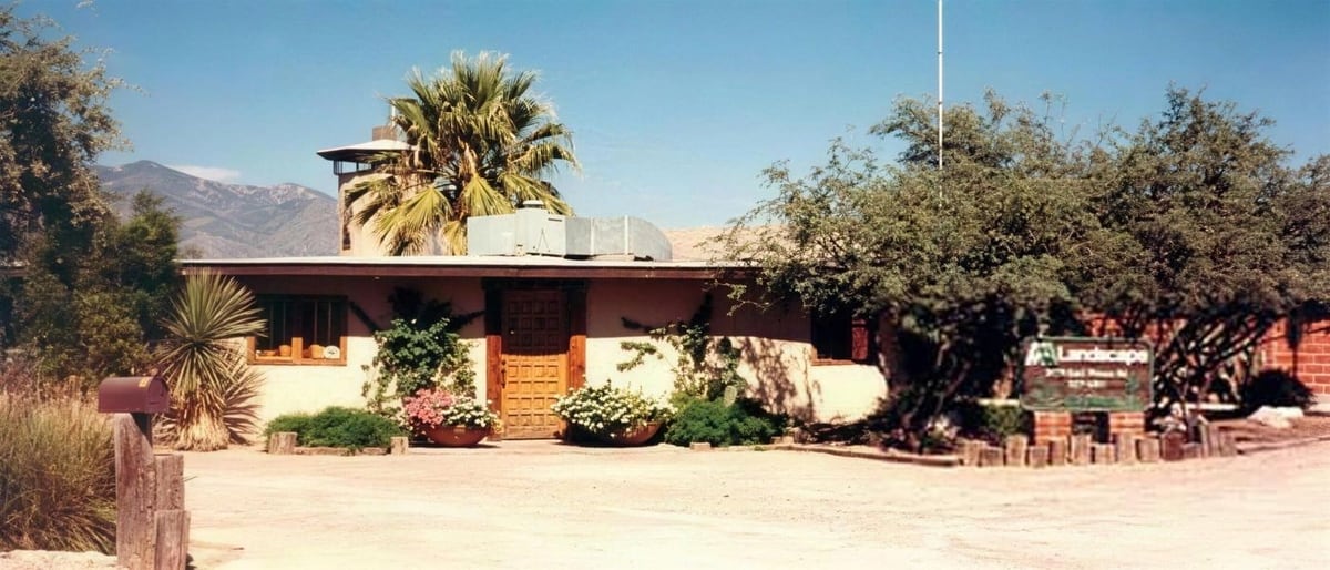 AAA Landscape’s first office, a low brick building surrounded by desert vegetation.